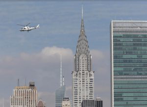 In this July 31 photo, a helicopter passes by the Chrysler Building in Manhattan. A Brooklyn man was arrested and charged on Monday after aiming a laser pointer at a helicopter near LaGuardia Airport. AP Photo/Seth Wenig
