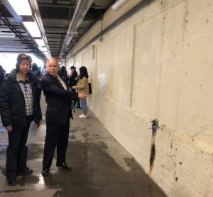 Assemblymember William Colton and Democratic District Leader Nancy Tong point to mold on the wall of the station platform. Photo by Paula Katinas