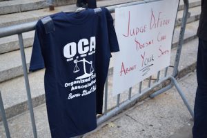 A navy blue t-shirt, designed by members of the state’s Court Officers Association, hangs on a barricade outside of 60 Centre St. in Manhattan during a protest on Oct. 23, 2018. Eagle photo by Christina Carrega