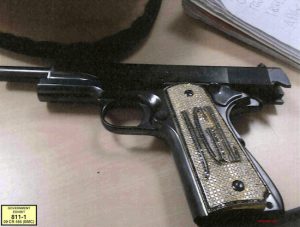 This undated photo provided by the U.S. Attorney's Office shows a diamond-encrusted pistol that a government witness said belonged to infamous Mexican drug lord Joaquin "El Chapo" Guzman, at Guzman's trial in New York, Monday, Nov. 19, 2018. Jurors were shown a photo of the pistol decorated with Guzman's initials. U.S. Attorney's Office via AP
