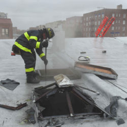 Firefighters works on roof to get at any additional fire.