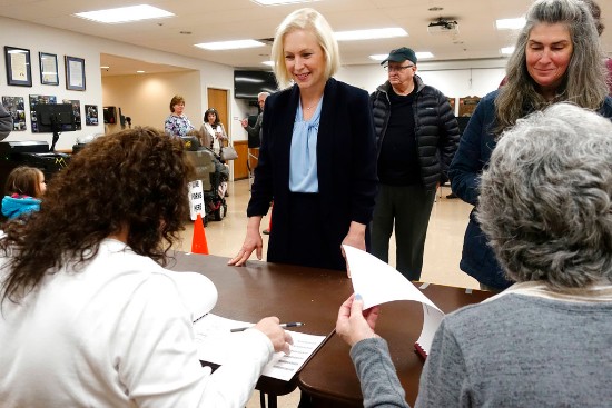 U.S. Senator Kirsten Gillibrand, left, checks in to vote at the Brunswick Fire Co. No 1 during Election Day, on Tuesday, Nov. 6, 2018, in Troy, N.Y. (Paul Buckowski//The Albany Times Union via AP