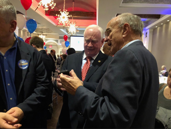 State Sen. Marty Golden and longtime ally Mike Long, chairperson of the New York State Conservative Party, look grim-faced as they check the latest vote count on Election Night in the Bay Ridge Manor. Photo by Paula Katinas