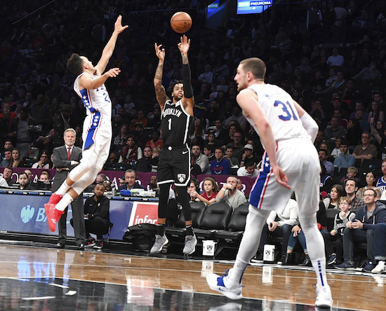 Brooklyn Nets guard D'Angelo Russell (1) shoots a three-point goal past Philadelphia 76ers guard Landry Shamet (23) and forward Mike Muscala (31) during the second half of an NBA basketball game, Sunday, Nov. 4, 2018, in New York. (AP Photo/Kathleen Malone-Van Dyke)