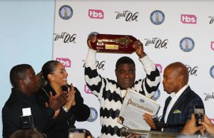 Comedian Tracy Morgan holds the Key to Brooklyn aloft while his wife, Megan Wollover, and son, Tracy Jr., applaud. Borough President Eric Adams reads from the accompanying proclamation. Eagle photo by Andy Katz