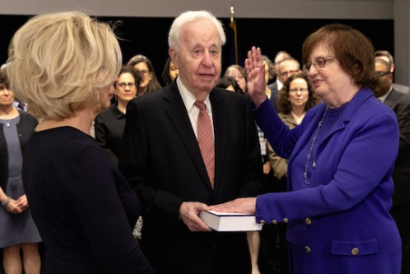 In this photo provided by the New York Attorney General's Office, Solicitor General Barbara Underwood, right, takes the oath of office at the State Capitol in Albany. Underwood became the state's acting Attorney General after Eric Schneiderman resigned amid accusations of abusing four women during intimate encounters. From left is New York Chief Judge Janet DiFiore, Underwood's husband Martin Halpern and Barbara Underwood. New York Attorney General's Office via AP