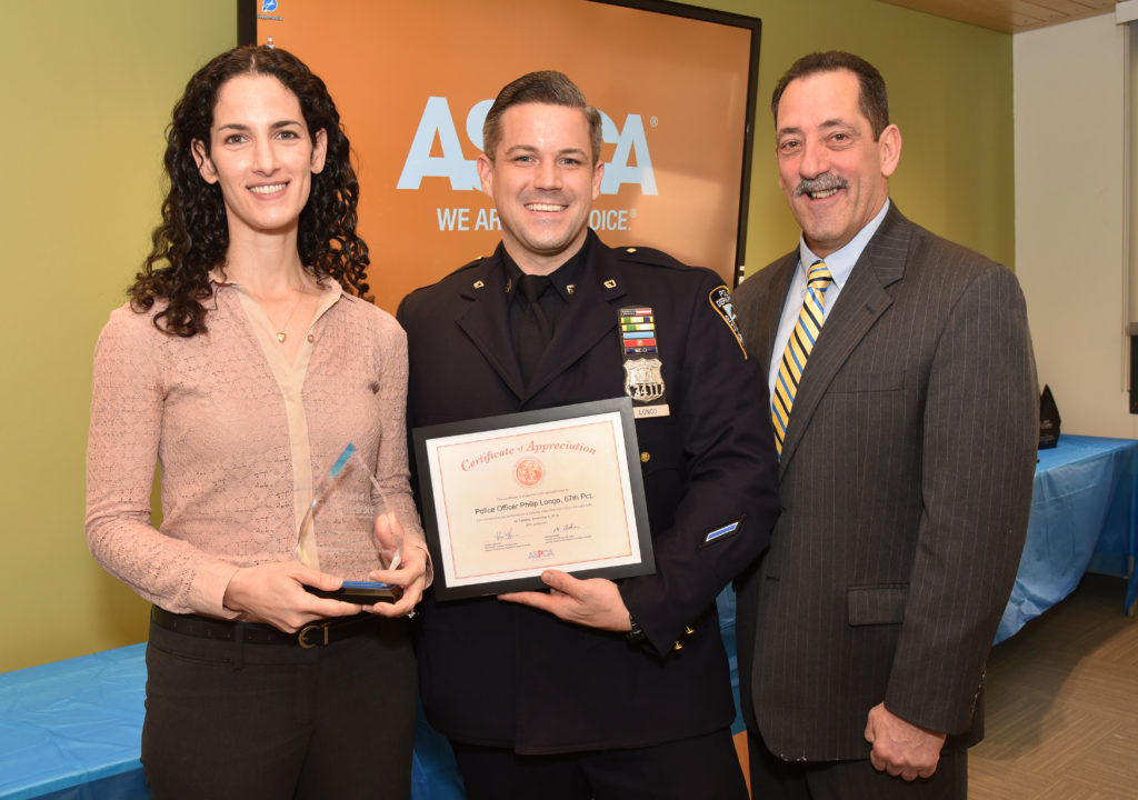Police Officer Philip Longo (center) receives his award from Elizabeth Brandler, legal advocacy senior counsel for the ASPCA, and ASPCA Vice President Howard Lawrence. Photo courtesy of ASPCA