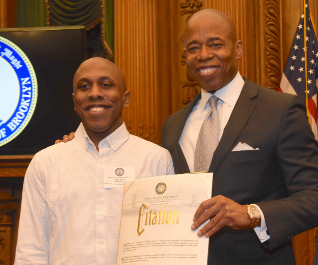 Alexander Harris, culinary director of Emma’s Torch, accepts the award from Borough President Eric Adams. Eagle photo by Todd Maisel