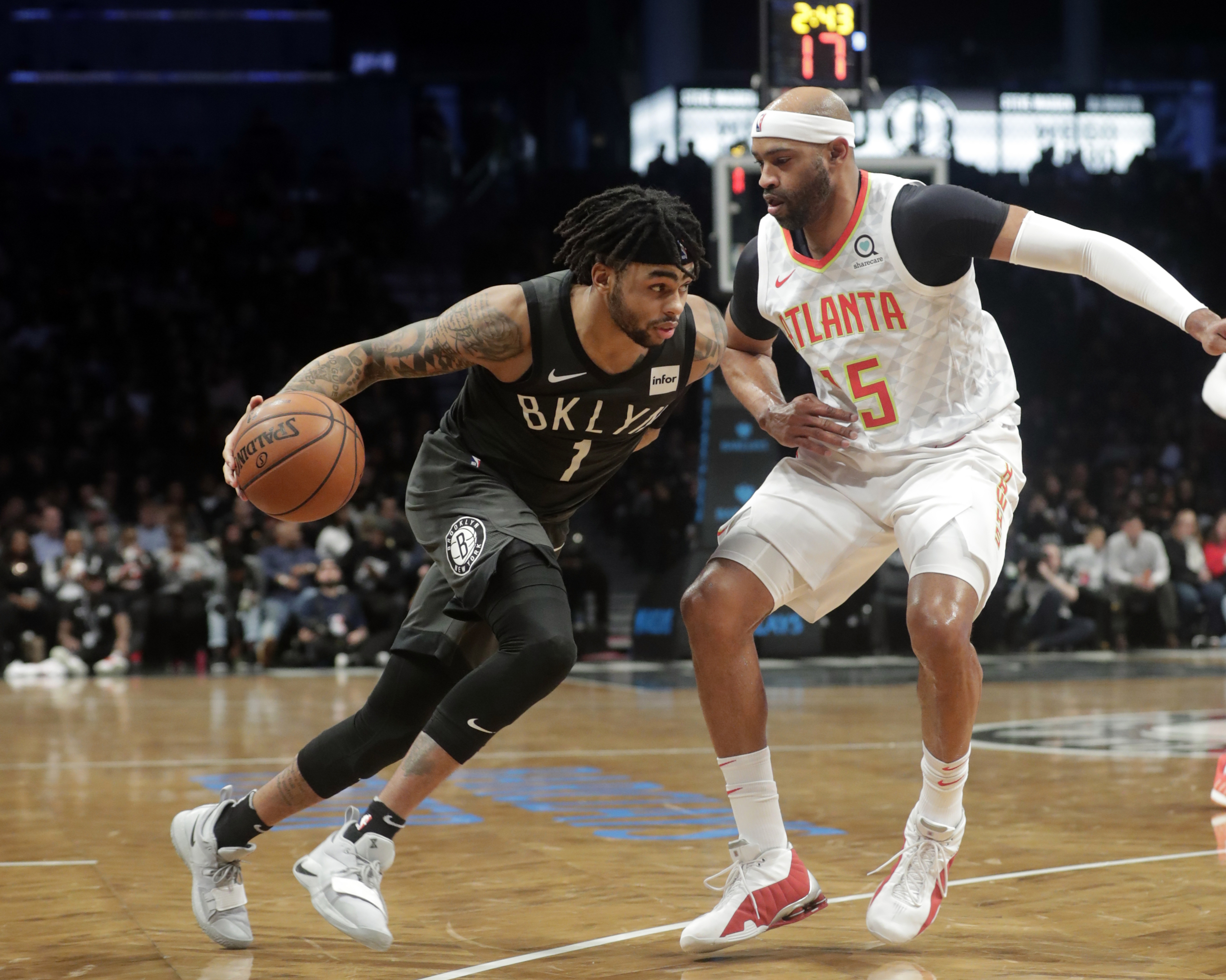 Brooklyn Nets' D'Angelo Russell (1) drives past Atlanta Hawks' Vince Carter (15) during the second half of an NBA basketball game Sunday, Dec. 16, 2018, in New York. The Nets won 144-127. (AP Photo/Frank Franklin II)