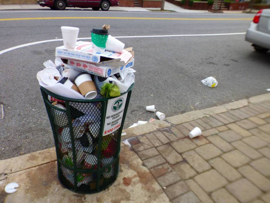 When the sun comes up and the tourists have gone home after seeing the Dyker Heights Christmas Lights Display, the streets of the neighborhood are filled with sights like this: an overflowing garbage cans. Photo by Tom Hilton