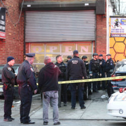 Police swarmed a wash and detailing shop on Remsen Avenue after the shooting, where they found the vehicle that one of the suspects was driving with a blown out window and bullet holes. Eagle photos by Todd Maisel