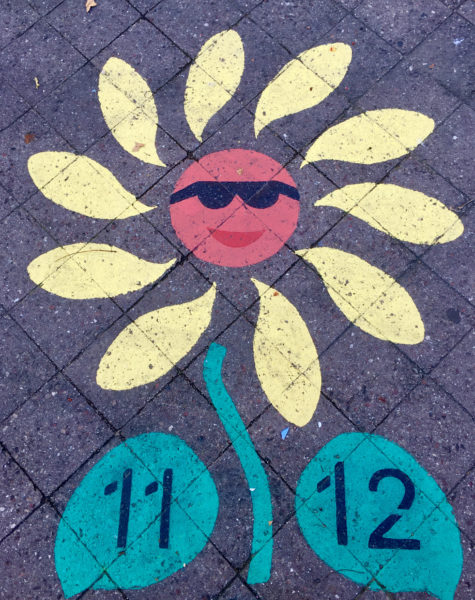 This flower is painted on the pavement at St. Marks Playground, which is located across from recently sold 939 and 947 St. Marks Ave.