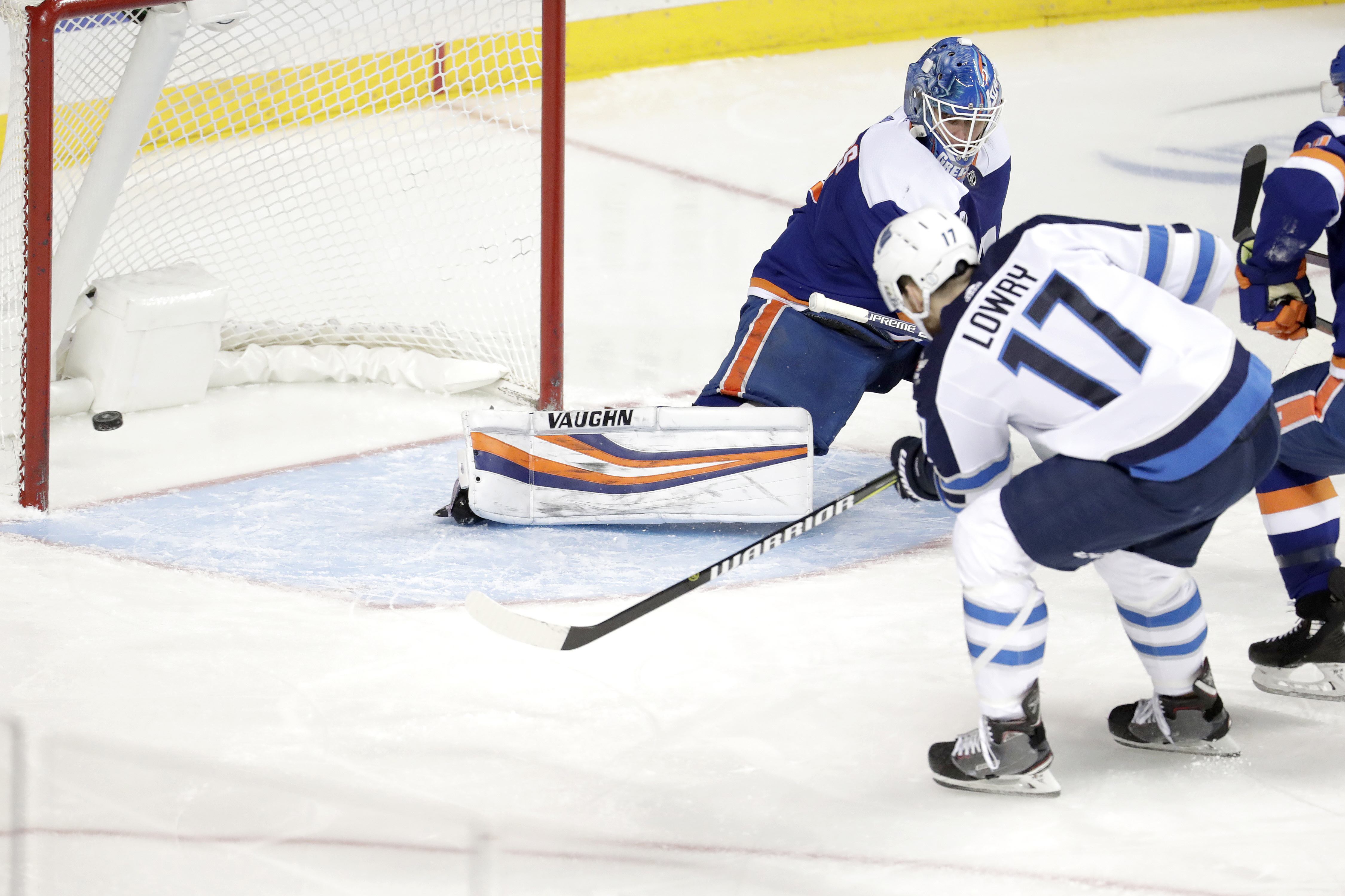 Winnipeg’s Adam Lowry scores the Jets’ second goal in 22 seconds Tuesday night at Barclays Center as the Isles suffered a late “lapse” in a 3-1 loss in their first game back in Brooklyn since returning to the renovated Nassau Coliseum on Saturday night. AP Photo by Julio Cortez