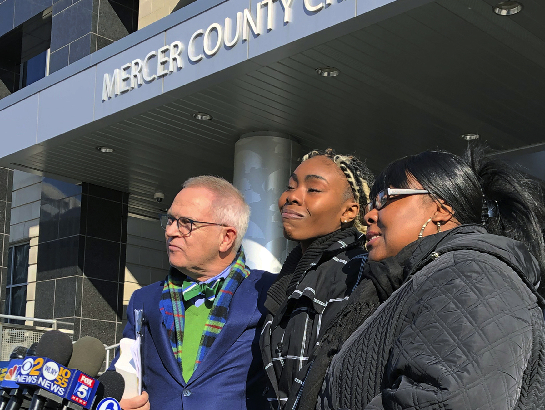 azmine Headley, center, joins attorney Brian Neary and her mother, Jacqueline Jenkins, outside a courthouse in Trenton, N.J., after she accepted a deal to enter a pretrial intervention program related to credit card theft charges she faced, Wednesday, Dec. 12, 2018. Headley said she's happy to be reunited with her son after being violently separated from her toddler by New York police in a widely viewed videotaped encounter. (AP Photo/Mike Catalini)
