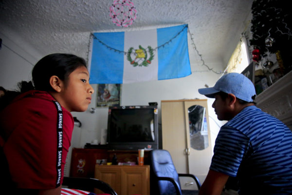 Manuela Adriana, 11, left, sit with her father Manuel Marcelino Tzah inside their apartment hours after her release from immigrant detention, Wednesday July 18, 2018, in Brooklyn borough of New York.  The Guatemalan asylum seekers were separated May 15 after they crossed the U.S. border in Texas. (AP Photo/Bebeto Matthews)