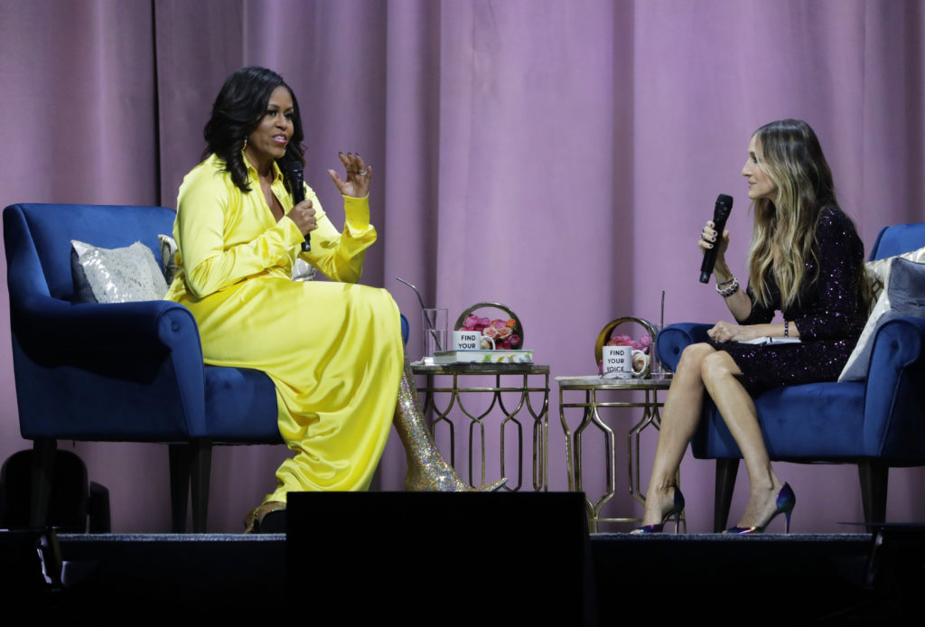 Former First Lady Michelle Obama, left, is interviewed by Sarah Jessica Parker during an appearance for her book, "Becoming: An Intimate Conversation with Michelle Obama" at Barclays Center Wednesday, Dec. 19, 2018, in New York. (AP Photo/Frank Franklin II)