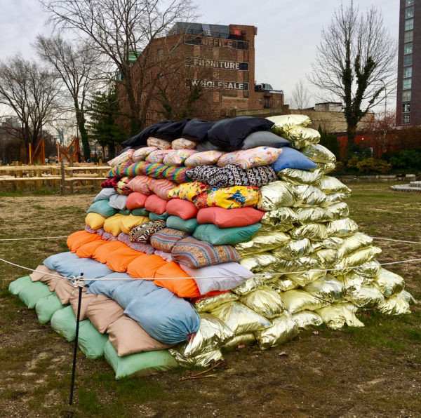 This enigmatic stack of sandbags is an artwork by Nancy Nowacek called “Maneuver” that's being exhibited at Socrates Sculpture Park.