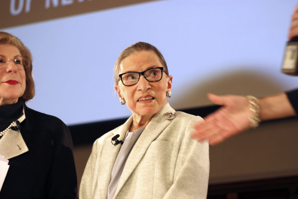 NPR's Nina Totenberg, left, and U.S. Supreme Court Justice Ruth Bader Ginsburg listen to Whitney W. Donhauser, president of the Museum of the City of New York, after participating in the David Berg Distinguished Speakers Series Saturday, Dec. 15, 2018 in New York. "The Notorious RBG" is now the subject of a second film about her this year — in theaters on Christmas Day. (AP Photo/Rebecca Gibian)