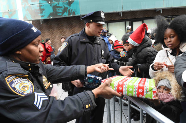 School safety officers hand out gifts to the children at Restoration Plaza on Fulton Street.