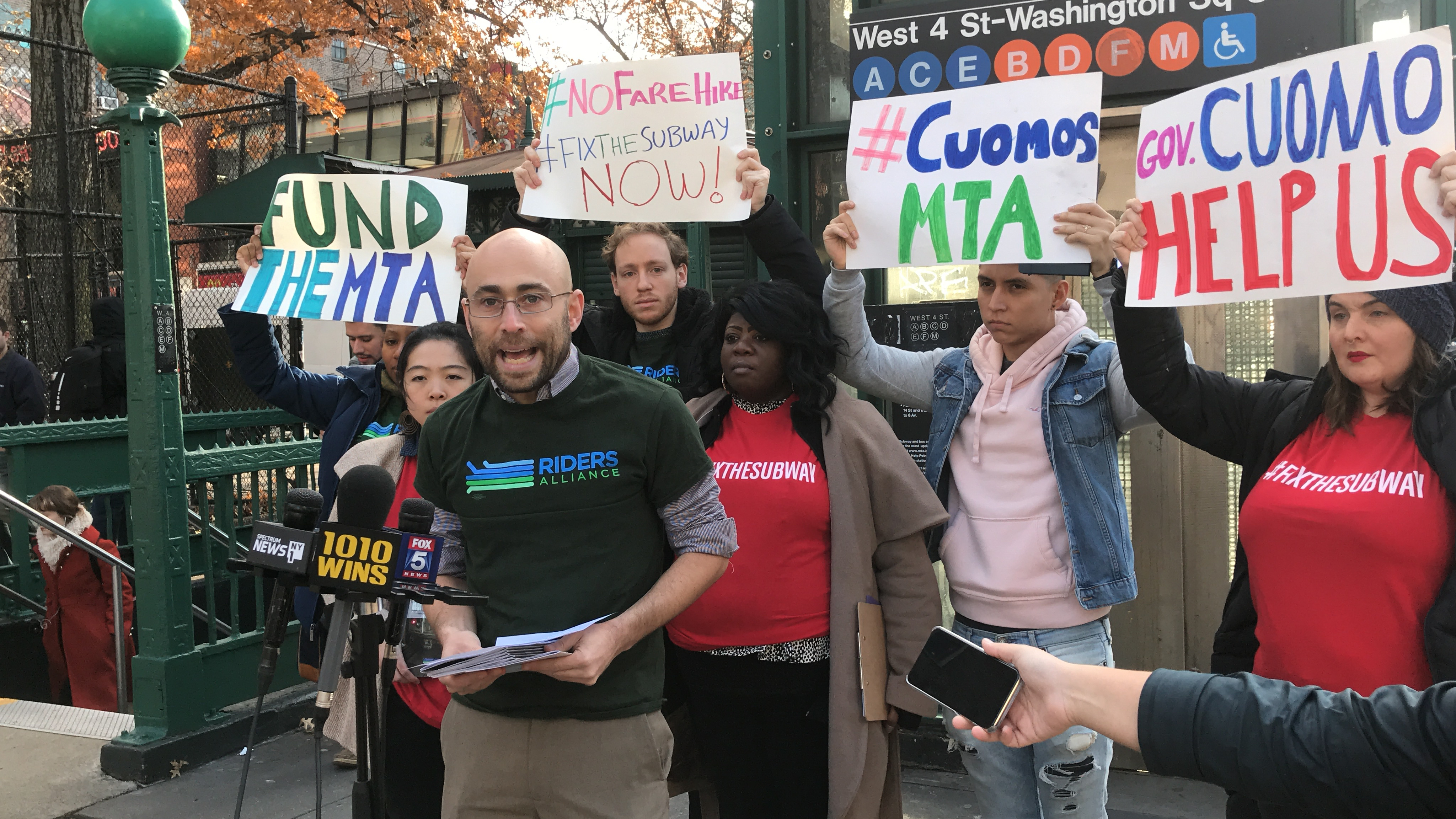 The Riders Alliance held a rally outside the West Fourth Street subway station in Greenwich Village to announce the hurried-up release of a new book detailing the nightmare rides commuters have taken on subways. Photo courtesy of Riders Alliance