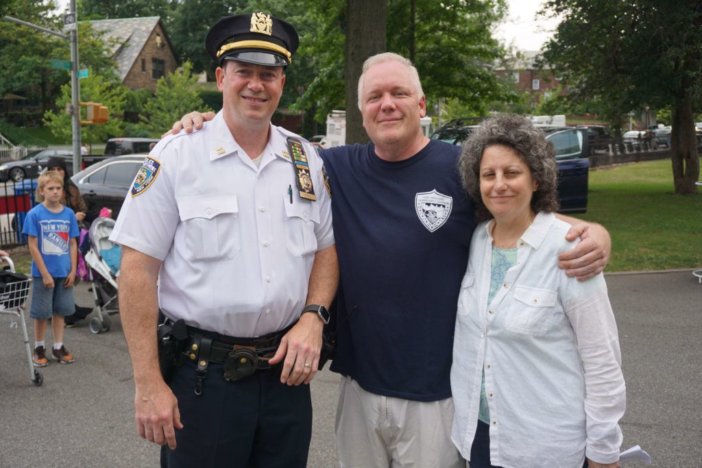 Capt. Robert Conwell (left) has assigned additional police officers to Dyker Heights at night during the holiday season. He is pictured with David Ryan, president of the 68th Precinct Community Council and Fran Vella-Marrone, president of the Dyker Heights Civic Association, at the Night Out Against Crime event in Bay Ridge in August. Eagle file photo by Helen Klein