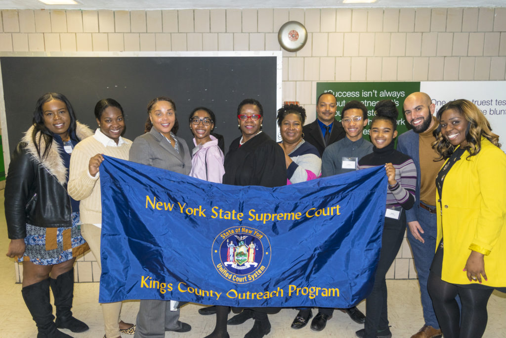 A few members of the Brooklyn court system took part in the first ever career day at Achievement First East Brooklyn High School. Pictured are court employees Yvonne Pritchett (third from left), Hon. Robin Sheares (center with red glasses) and Charmaine Johnson (sixth from right) with students and faculty from Achievement First East Brooklyn High School. Eagle photos by Rob Abruzzese