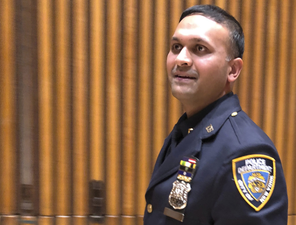 New York City police officer Syed Ali walks out of a briefing room at police headquarters, Thursday, Dec. 27, 2018, after speaking to reporters about his battle with three homeless men who came at him as he patrolled a Manhattan subway station on Sunday, Dec. 22. Ali has been widely praised for his response, which was caught on a video that has gone viral. Charges were brought against Ali's assailants after the video of the attack was viewed more than 4.75 million times on social media. (AP Photo/Michael R. Sisak)