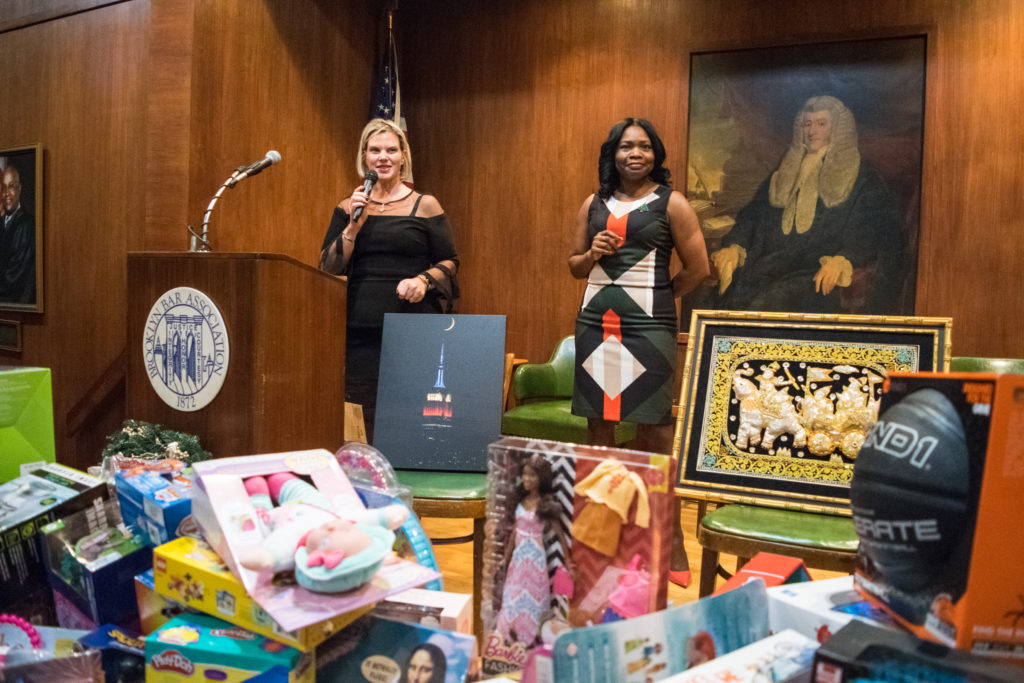 Brooklyn Women's Bar Association President Carrie Anne Cavallo (left) and Justice Genine Edwards helped to host the association's annual Holiday Party, where they raised money and collected toy donations for victims of domestic violence. Eagle photos by Rob Abruzzese