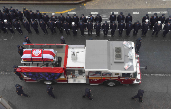 Coto’s coffin was carried from the funeral home atop a fire truck.