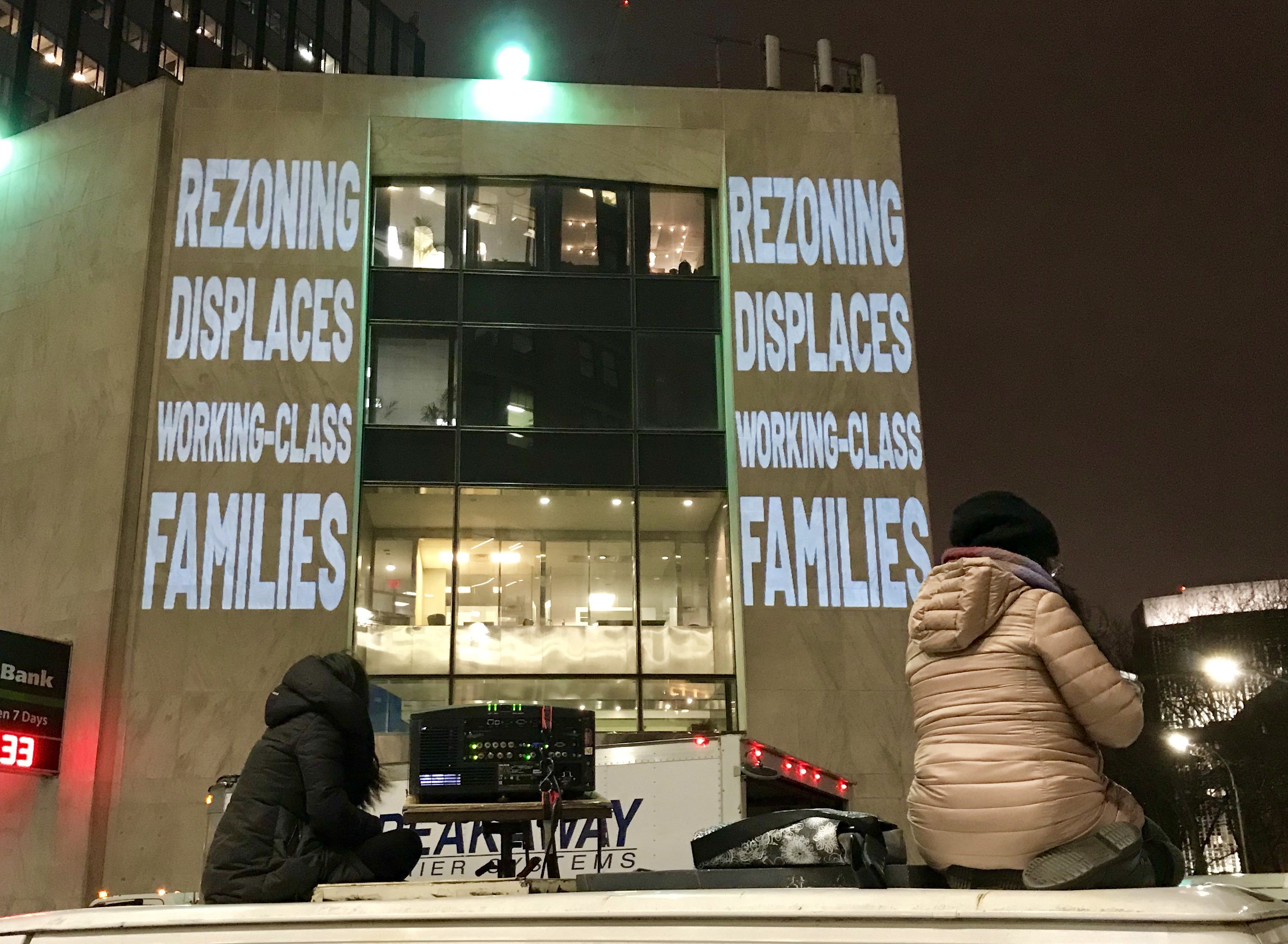 Slogans like “De Blasio, stop selling us out!” and others were projected onto the facade of TD Bank in Brooklyn Heights Monday night. Activist groups G-REBLS and Mi Casa No Es Su Casa say a plan to rezone Bushwick fails to protect existing tenants, many people of color. Eagle photo by Mary Frost