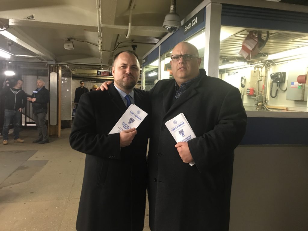 City Council Speaker Corey Johnson and Councilmember Justin Brannan held a press conference in the 77th Street R train station in conjunction with surveying riders about their commute. Eagle photo by Meaghan McGoldrick