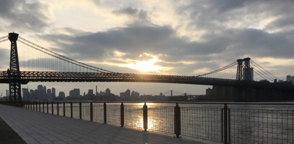 From Domino Park's esplanade, you get a good view of the sun setting behind the Williamsburg Bridge.
