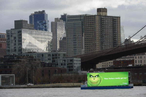 The controversial advertising barge passes by Brooklyn Heights.