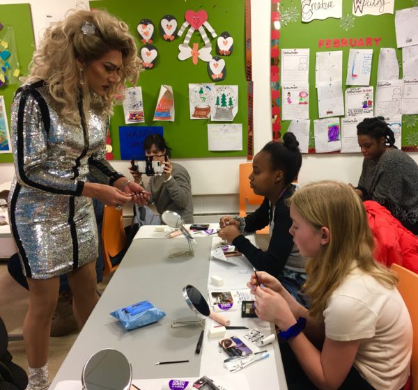 Drag queen Cholula Lemon shares makeup tips with Aster (left) and Aila (right) at Cortelyou Library.