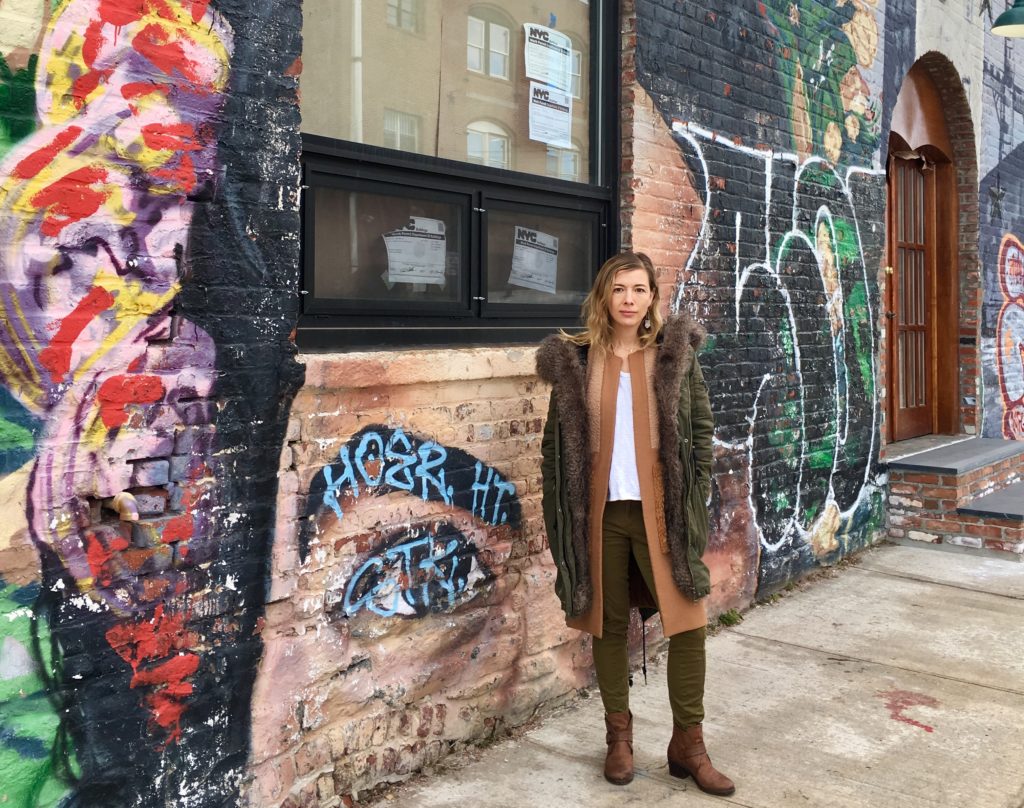 Victoria Alexander of Realty Collective stands outside 204 Van Dyke St. in Red Hook. Eagle photo by Lore Croghan