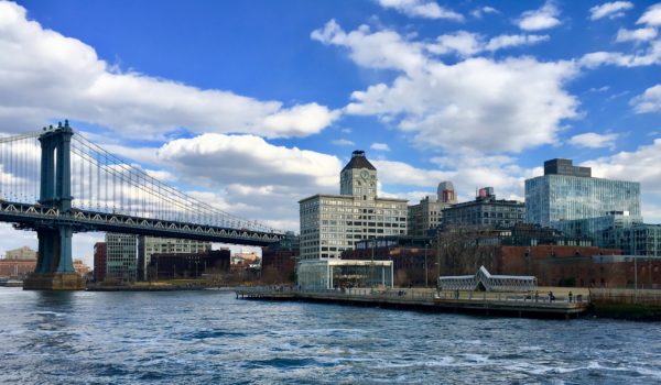 Jane’s Carousel,  DUMBO’s Clocktower Building and the Manhattan Bridge are triple icons on DUMBO’s shoreline. Eagle photo by Lore Croghan 