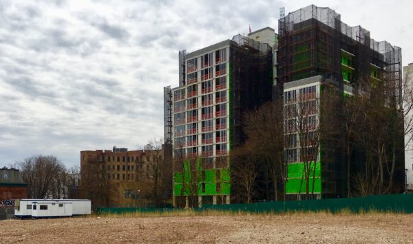 The building under construction is the 111 Montgomery Street Condominium. The vacant lot is 40 Crown St. Eagle photo by Lore Croghan