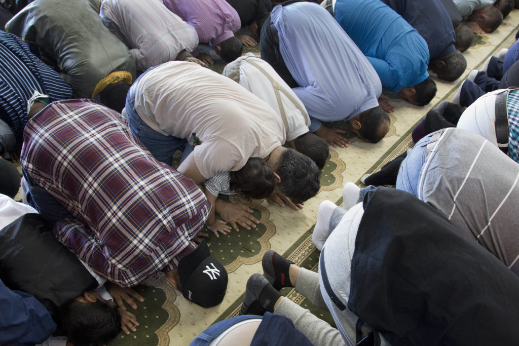 Men pray at Masjid Al-Farooq during Eid al-Fitr in Downtown Brooklyn. AP Photo/Mark Lennihan