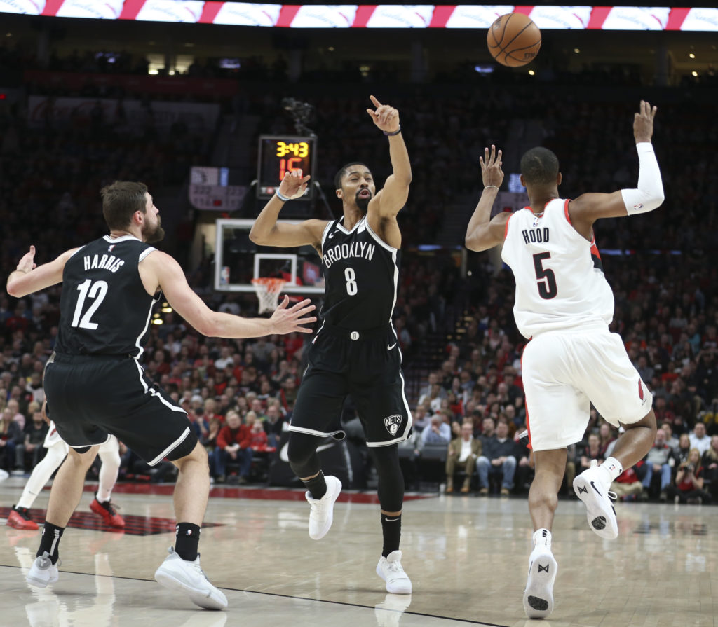 Spencer Dinwiddie and Joe Harris (left) look to grab a free ball Monday night in Portland during the Nets’ double-overtime loss to the Trail Blazers.(AP Photo/Randy L. Rasmussen)