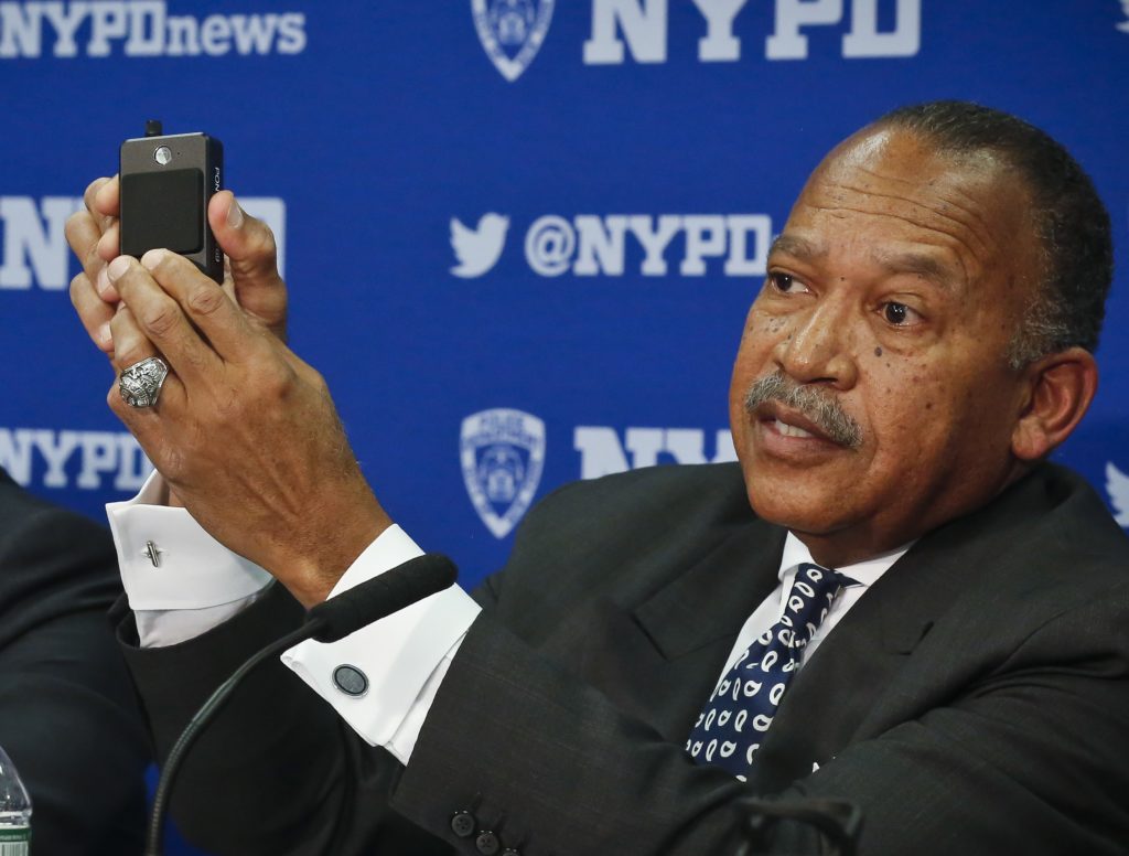 NYPD Deputy Commissioner Benjamin Tucker displayed at a January press conference one of the body cameras now worn by all uniformed cops on patrol. AP file photo by Bebeto Matthews