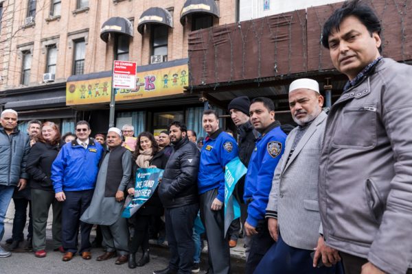 Muslim community members stand with people are various faiths as well as officers from the NYPD outside Makki Masjid. Eagle photo by Paul Frangipane