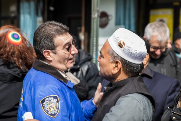 Deputy Inspector Paul Valerga greets worshipers after they’ve left the afternoon prayer. Eagle photo by Paul Frangipane