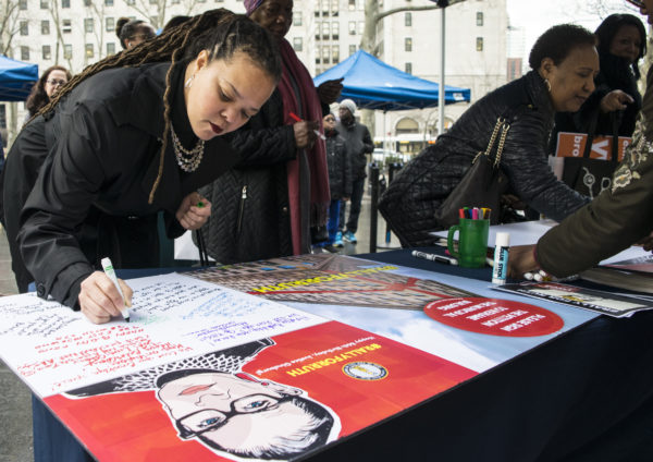 Judge Patria Frias Colon signs a birthday card for Justice Bader Ginsburg. Eagle photo by Rob Abruzzese