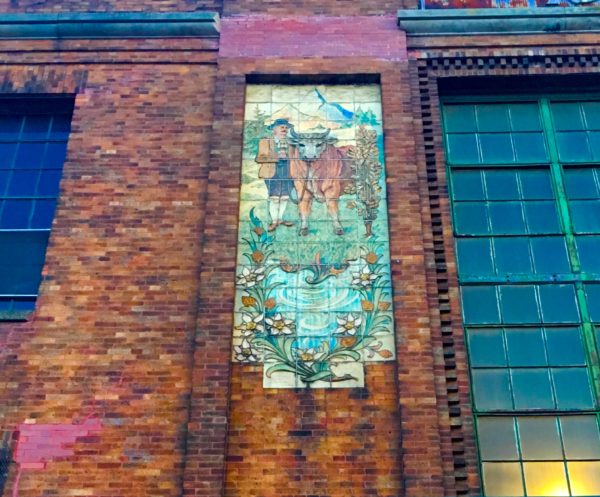 Unusual murals adorn the Empire State Dairy Company Buildings’ facade. Eagle file photo by Lore Croghan