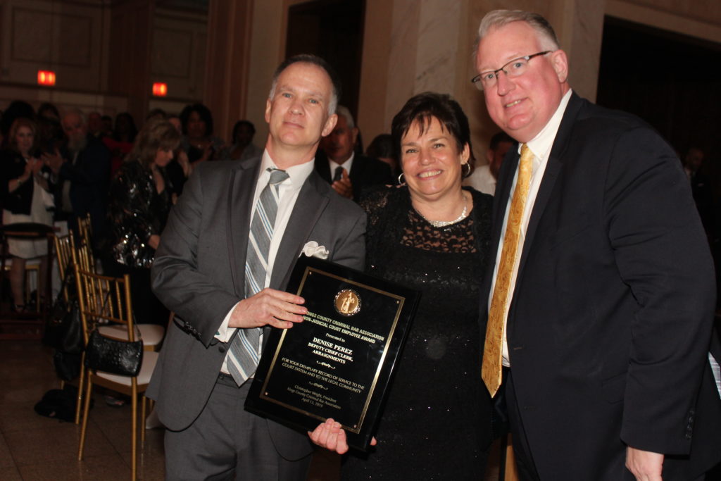 The Kings County Criminal Bar Association honored four including court clerk Denise Perez during its annual dinner at Giando on the Water. Perez is pictured here with KCCBA President Christopher Wright, left, and Hon. Michael Yavinsky, right, supervising judge of the Brooklyn Criminal Court. Eagle photo by Mario Belluomo