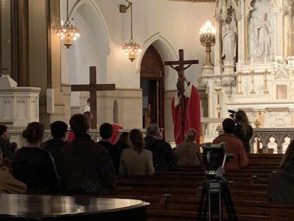 Father Paul Anes raises the cross on Good Friday at the Parish of St Paul & St. Agnes in Cobble Hill. Eagle photo by Noah Goldberg.
