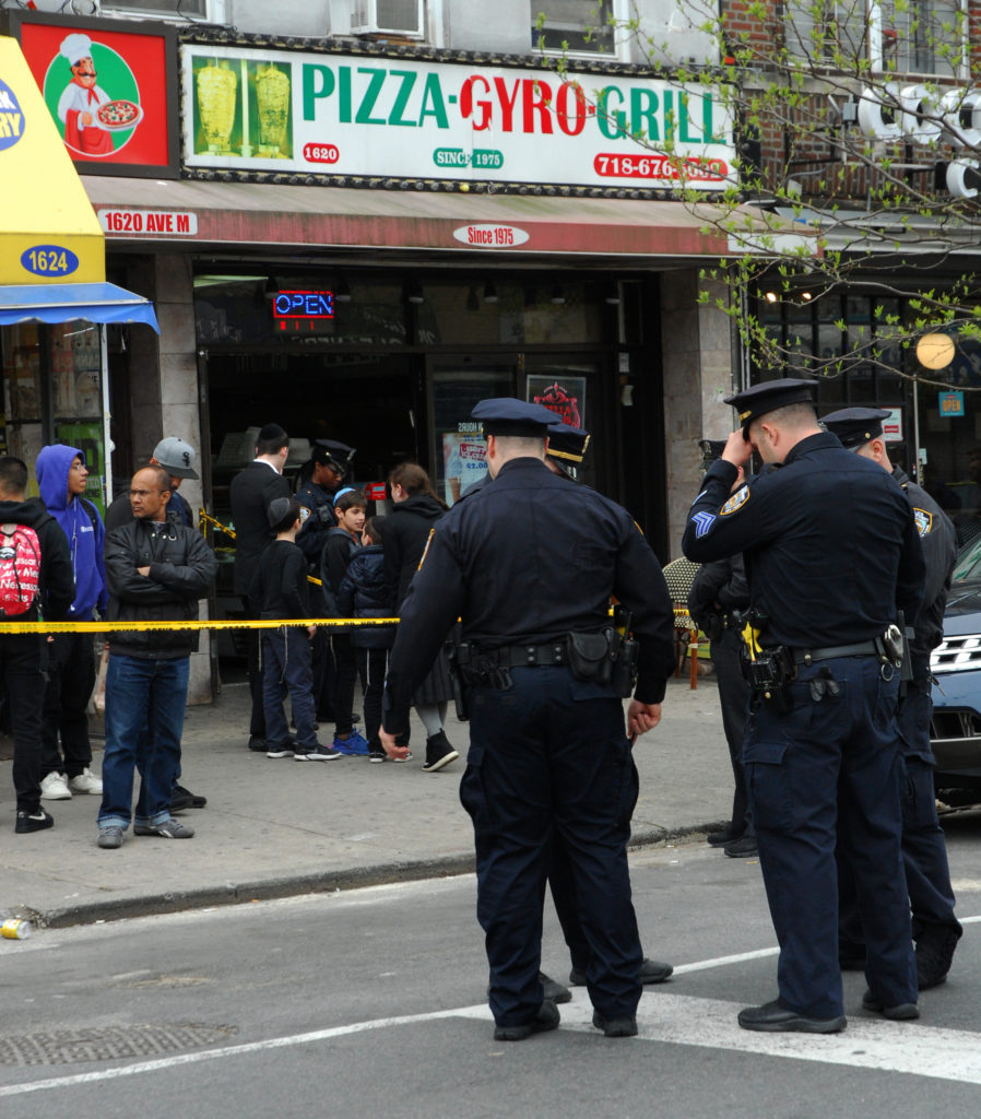Police cordoned off the pizza place where Rohan Burke, 17, bled out after being stabbed on Monday. Eagle photo by Arthur de Gaeta.