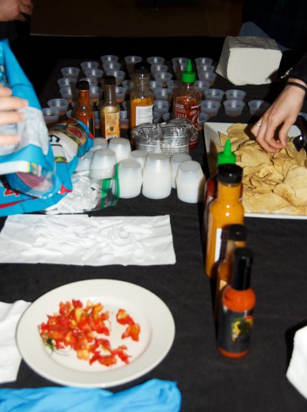 Attendees try out various hot sauces and the Carolina reaper pepper. Eagle photo by Scott Enman