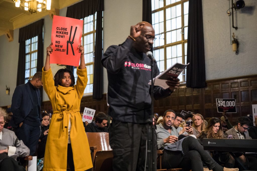 Darren Mack (right) speaks at a public hearing on the renovation of the Brooklyn Detention Complex. Brittany Williams (left), a member of No New Jails NYC, stands behind him. Eagle file photo by Paul Frangipane.