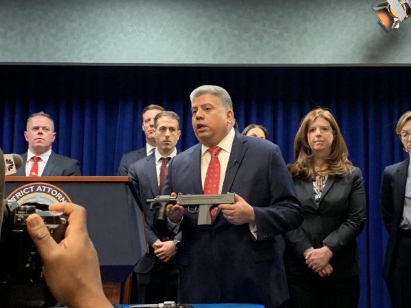 Brooklyn District Attorney Eric Gonzalez shows reporters a machine gun recovered in an NYPD undercover sting of a gun-trafficking ring. Eagle photo by Noah Goldberg.